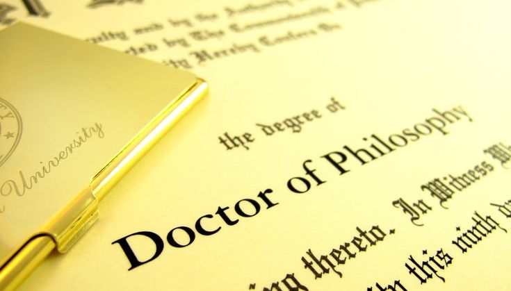 a close up of a book on top of a paper with the word doctor of philosophy written in it