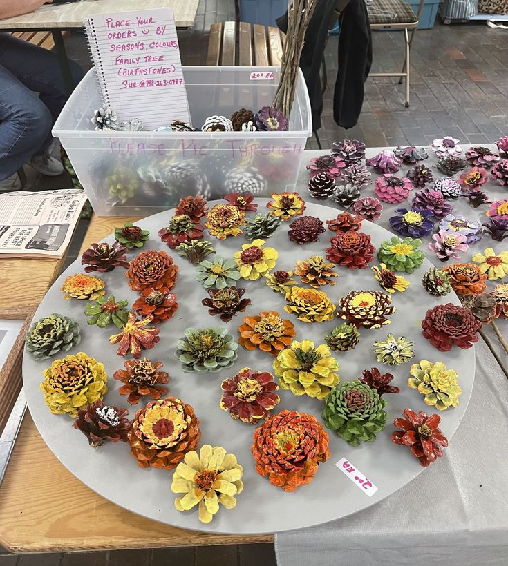 there are many different flowers on the plate and in front of it is a sign