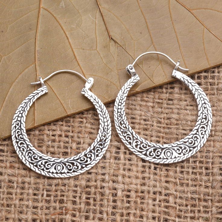 Make an impression with these stunning hoop earrings from Bali's Dwi Adiastuti. The earrings are crafted from sterling silver with ornate details. J Bali Earring, Silver Filigree Hoop Earrings For Festival, Silver Bali Earrings, Bollywood Style Intricate Silver Hoop Earrings, Filigree Hoop Earrings, Bali Earrings, Sterling Silver Hoop Earrings, Sterling Silver Hoops, Jewelry Packaging