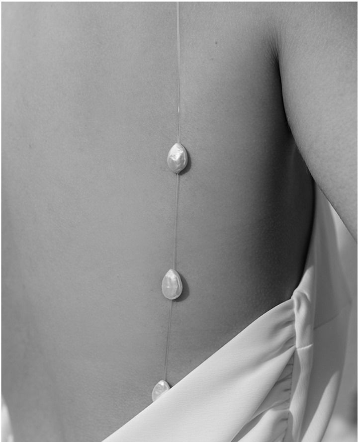 the back of a woman's dress with buttons on it