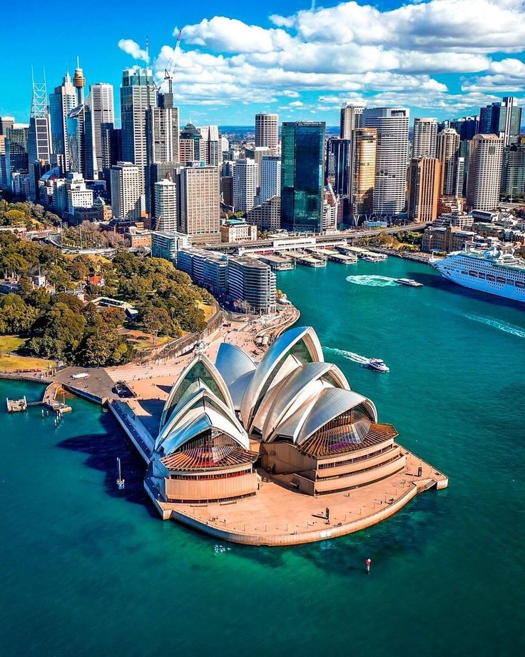 an aerial view of sydney, australia with the opera house in the foreground and city buildings in the background