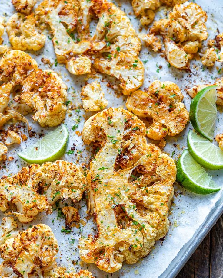 a tray with cauliflower and limes on it