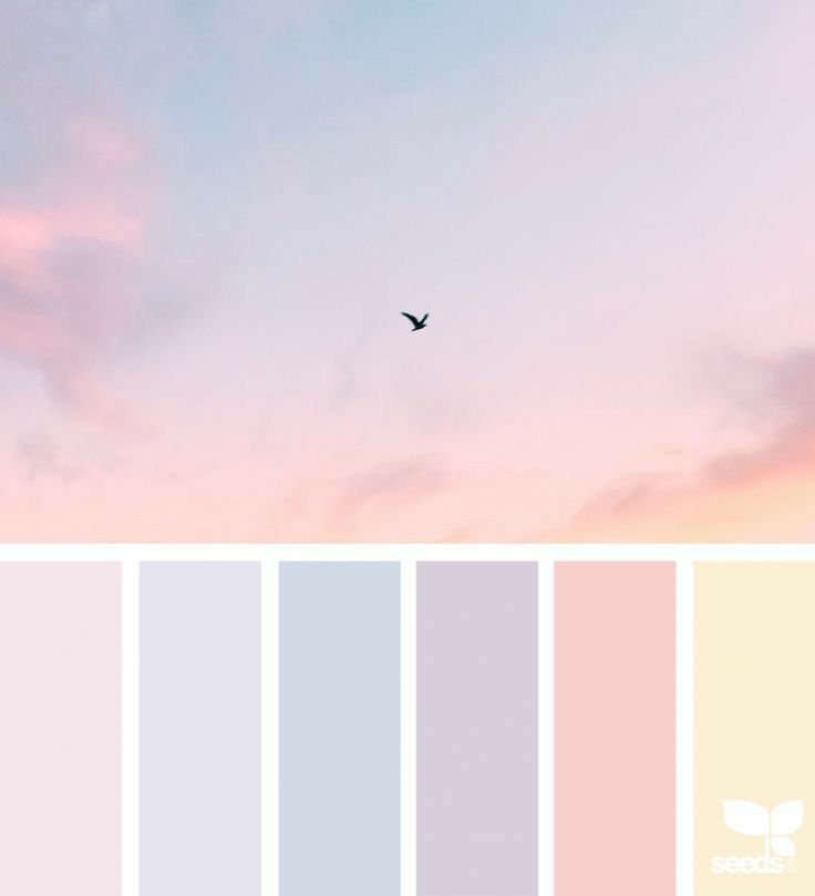 there is a bird flying in the sky with colors that are pink, blue and yellow