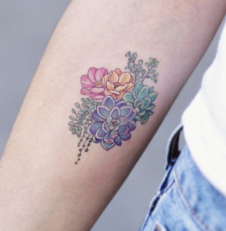 a woman with a flower tattoo on her arm