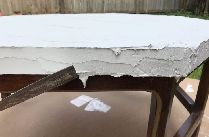 a piece of wood that has been painted white and is being used as a table