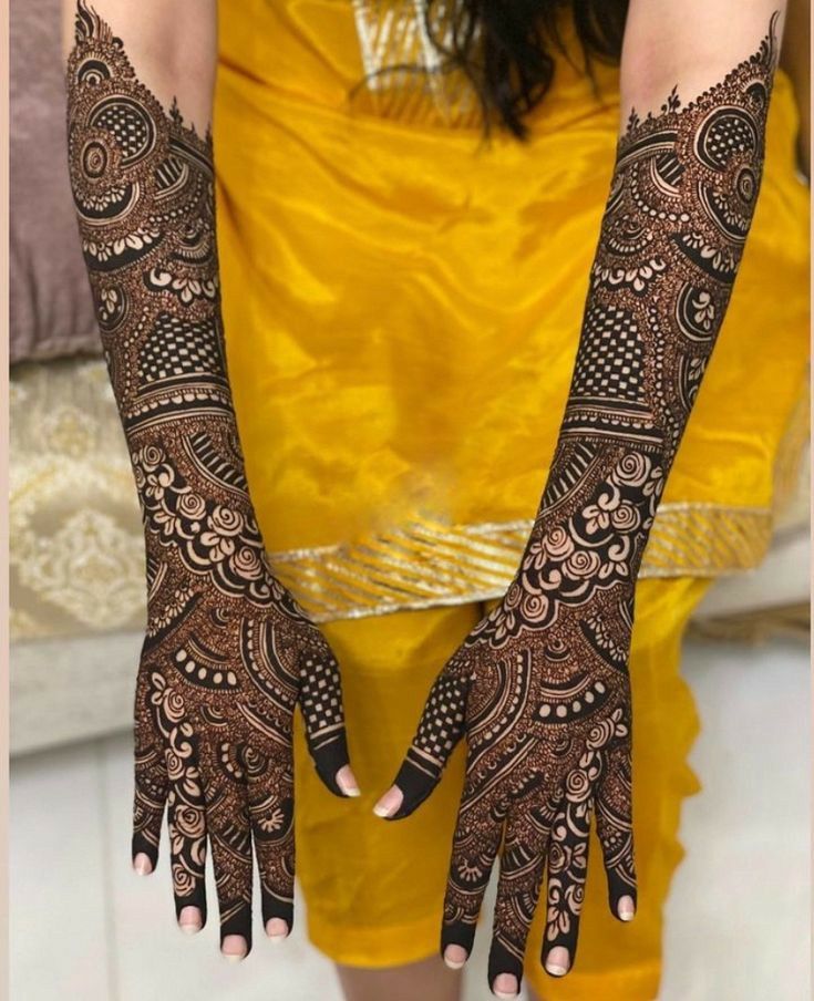 two hands with henna tattoos on them