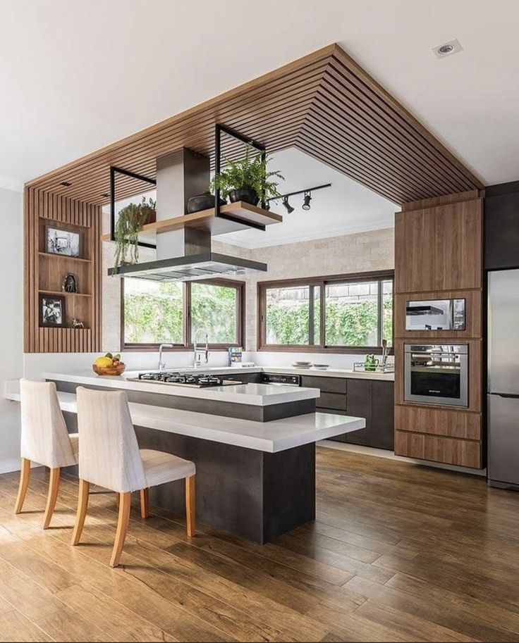 a kitchen with wooden floors and white chairs