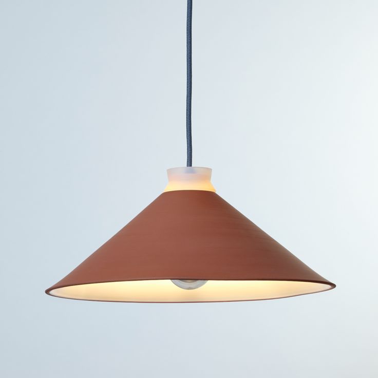 a brown and white light hanging from a ceiling