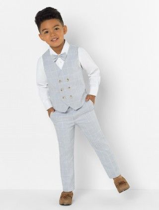 a young boy wearing a suit and bow tie posing for a photo in front of a white background