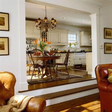 a living room filled with furniture next to a dining room table and chairs on top of a hard wood floor