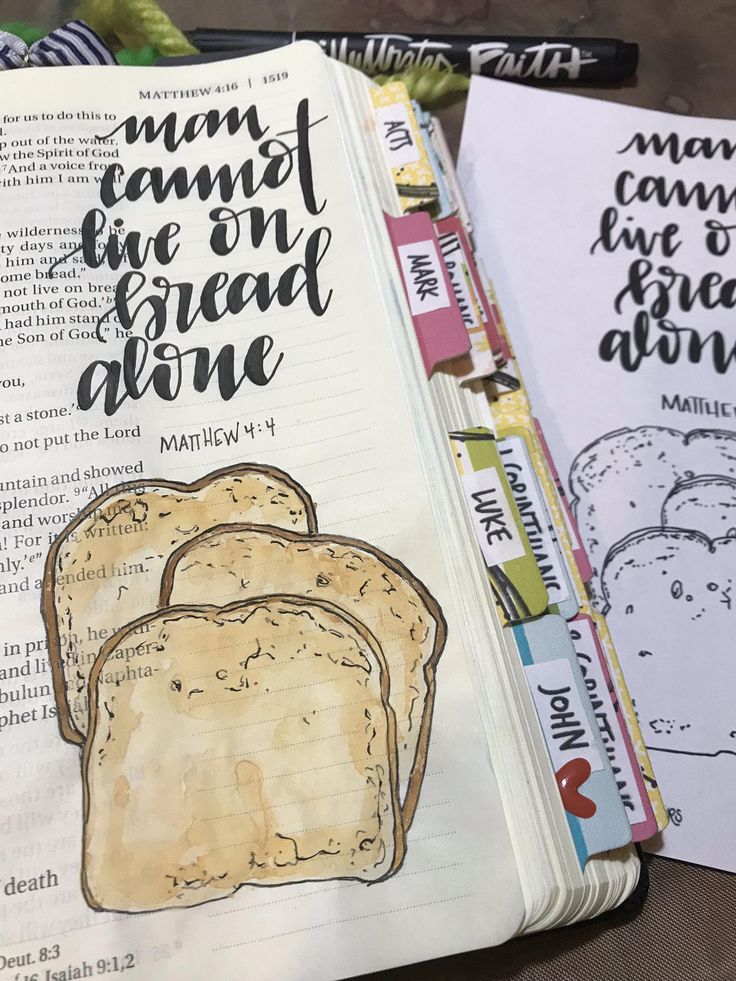 an open bible with bread drawn on it and some other coloring pages in the background