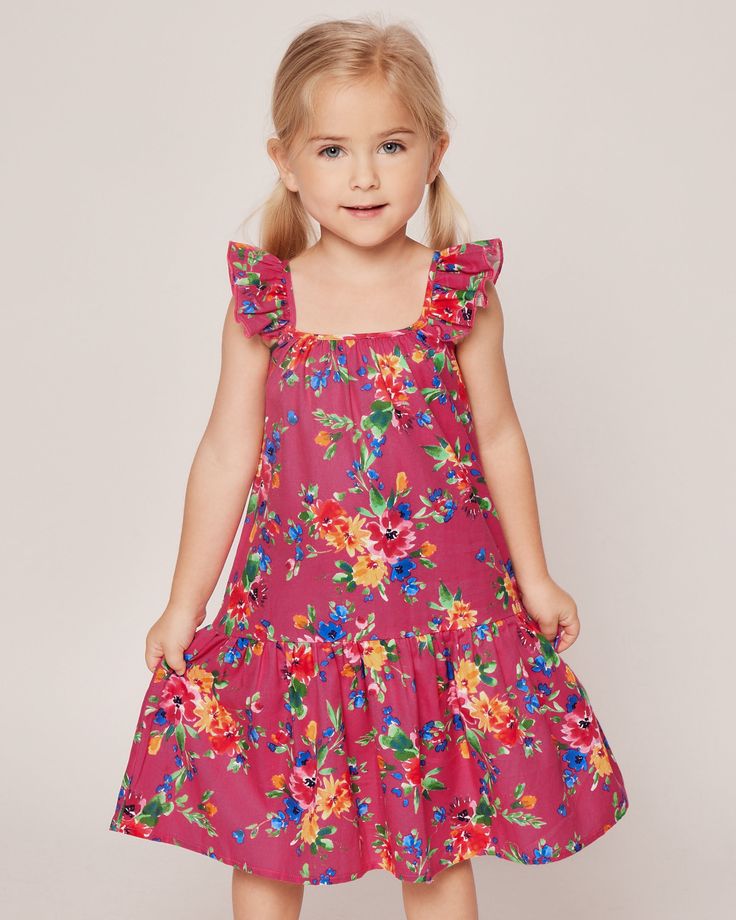 A celebration of summer's playful spirit. Vibrant blooms in hues of yellow, red, blue, and green dance on a sizzling hot pink canvas, exuding a sense of fun and joy. Embrace the lively energy of the summer season with this playful print, perfect for adding a bold splash of color to your sleepwear collection. The Celeste Lounge Dress boasts a lovely flutter at the shoulder and a comfortable a-line midi-length silhouette. A pretty gathered tier at the hem is our nod to your favorite summer sun dre Playful Floral Spring Dress, Playful Floral Sundress For Summer, Playful Floral Print Sundress For Summer, Playful Floral Print Dress For Garden Party, Vibrant Multicolor Print Summer Dress, Pink Sundress For Playtime In Summer, Playful Floral Print Dress For Vacation, Playful Sundress For Summer Garden Party, Playful Sundress For Garden Party In Summer