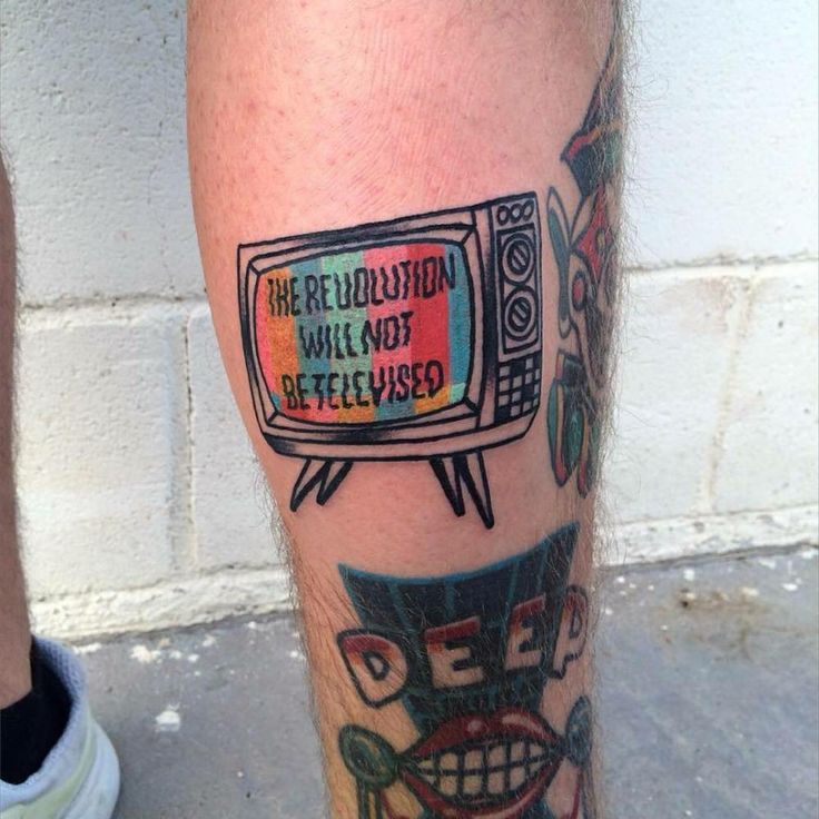 a man's leg with an old tv tattoo on it and the words television will not be televised