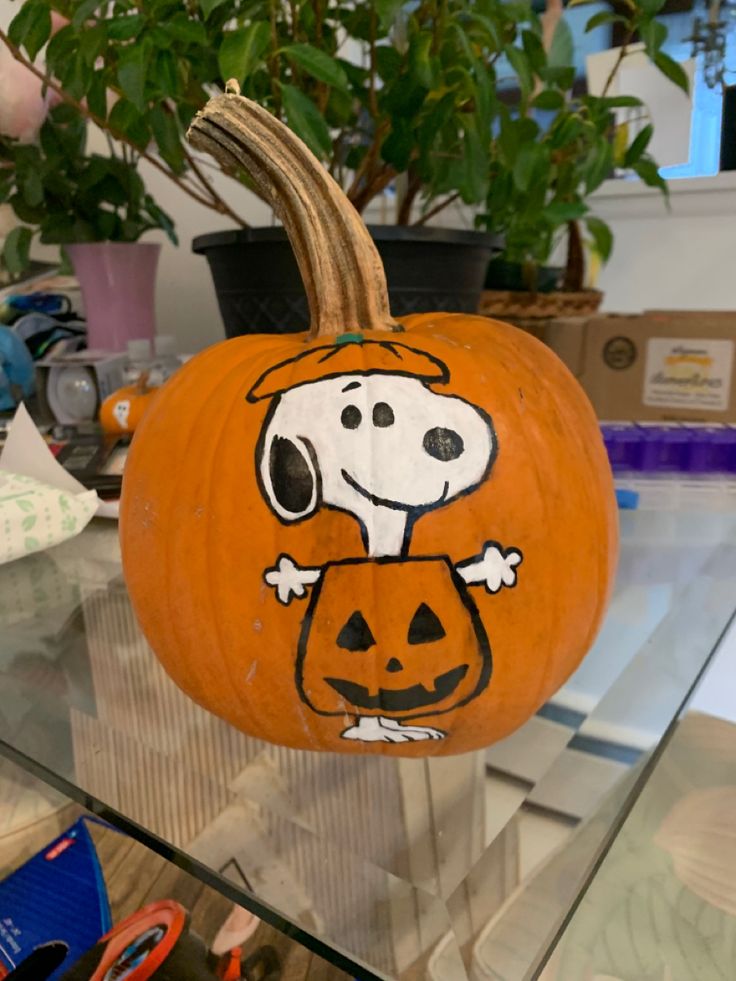 a pumpkin decorated with a dog on it