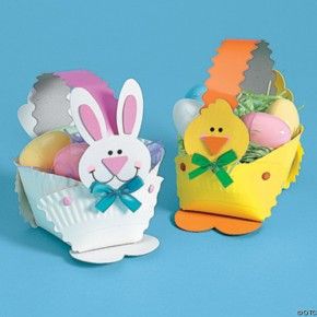 two easter baskets filled with colorfully decorated eggs and an egg in the shape of a chicken