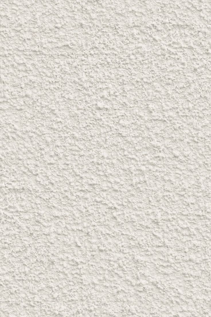 a white stucco wall textured with light gray paint