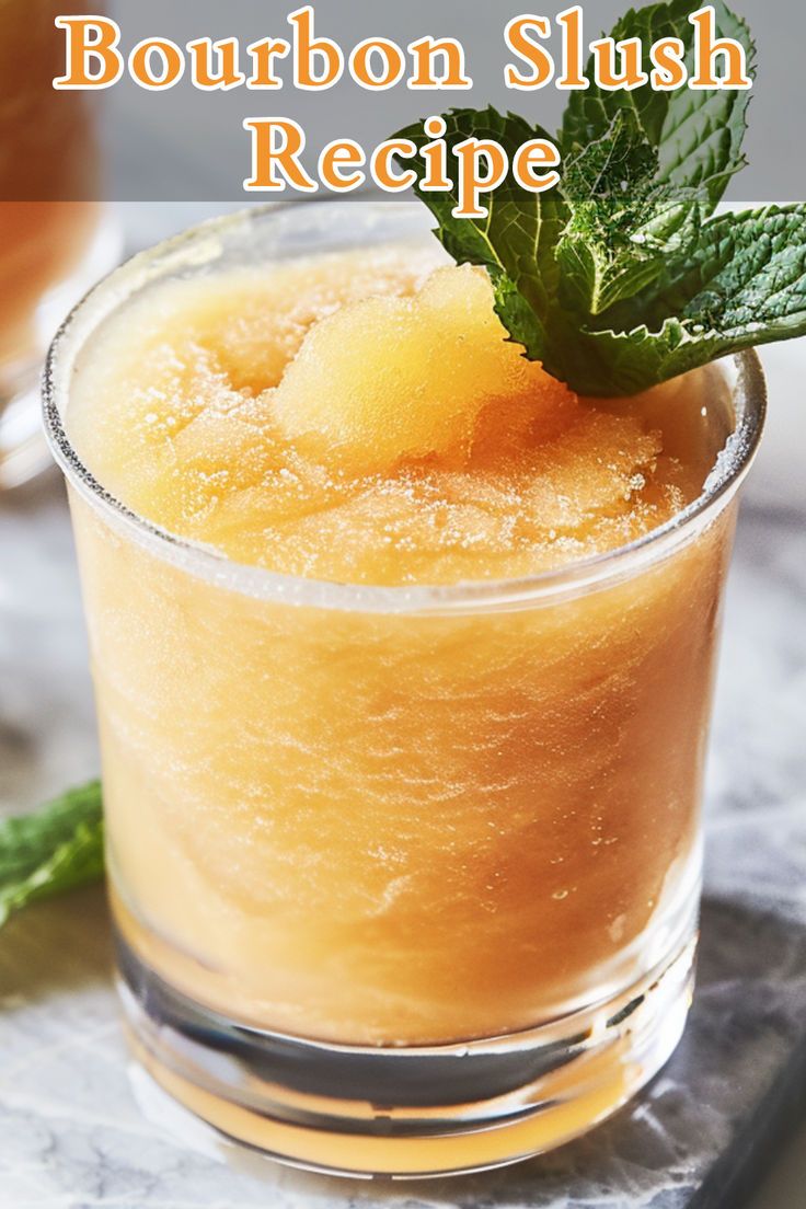 bourbon slushy recipe in a glass with mint garnish on the rim