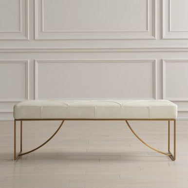 a white bench sitting on top of a hard wood floor in front of a wall