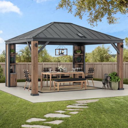 a gazebo sitting on top of a lush green field