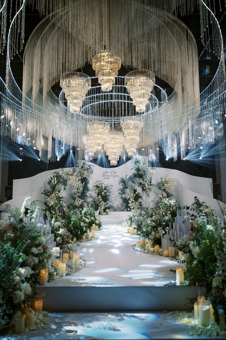 an elaborate wedding ceremony with chandeliers and flowers