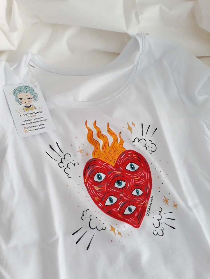 a white t - shirt with an image of a heart on the front and eyeballs on the back