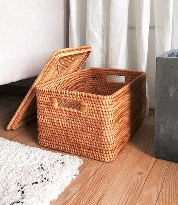 two baskets sitting on the floor next to each other