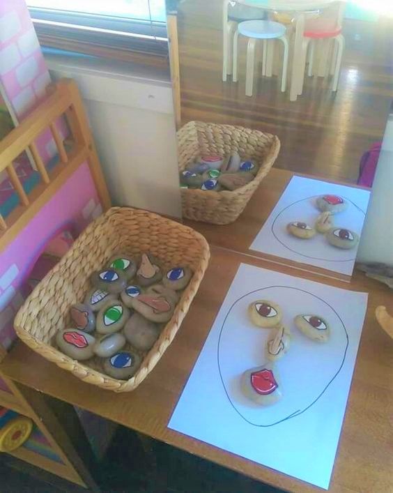 two baskets filled with rocks sitting on top of a table next to paper and markers