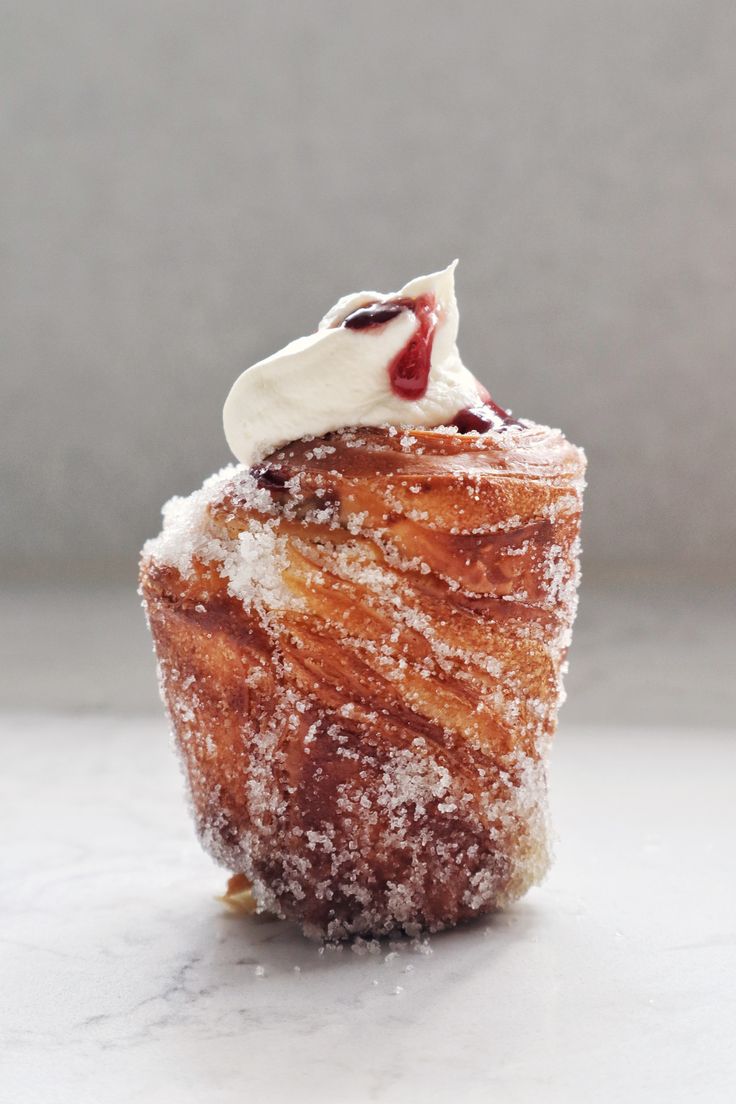 a pastry with powdered sugar and icing on top