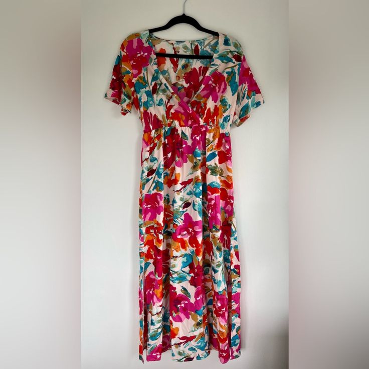 Reposh! This Bright Floral Patterned Dress Is Lightweight And Airy. It’s Short Sleeved With A Deep V-Neck And A Cinched Waist. It Comes With A Tie Belt To Add Some Flair. There Are Mid-Length Slits On Either Side. Reposhing Because It’s A Little Too Long For Me At 5’4”. Brand New With Tags, Never Worn. Pink V-neck Rayon Dress, Spring Vacation Short Sleeve Maxi Dress, Multicolor Short Sleeve Floral Dress For Summer, Short Sleeve Multicolor Floral Dress For Summer, Pink Rayon Summer Maxi Dress, Pink Rayon Midi Beach Dress, Pink Rayon Maxi Dress For Summer, Printed Short Sleeve Dress For Brunch, Pink Flowy Rayon Midi Dress