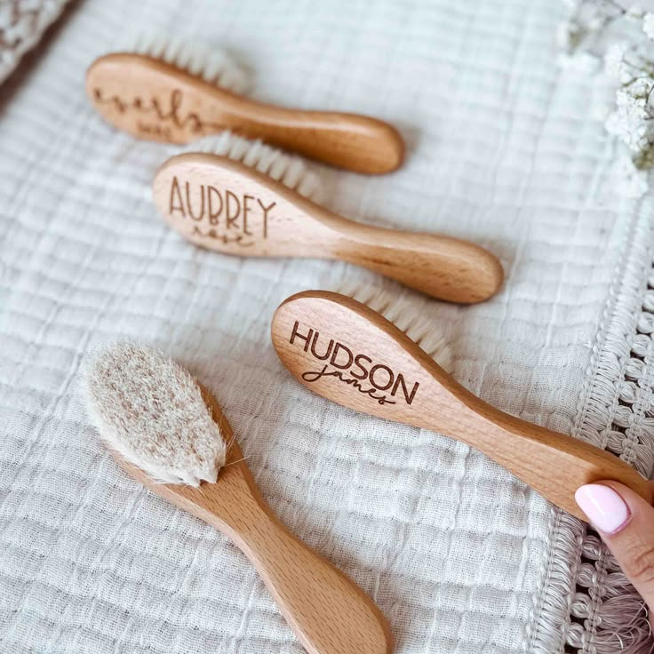 **Capitalization will appear exactly as shown on product photo** Handmade in our offices, and personalized with your baby's name! These natural wood baby brushes have soft bristles made from all natural goat hair that you can softly brush your baby’s hair with for both grooming and relaxation. Perfect brush for a healt Personalized Baby Girl Gifts, Engraved Baby Gifts, Caden Lane, Personalized Swaddle Blanket, Personalized Swaddle, Wood Hangers, Soft Spot, Baby Shampoo, Goat Hair