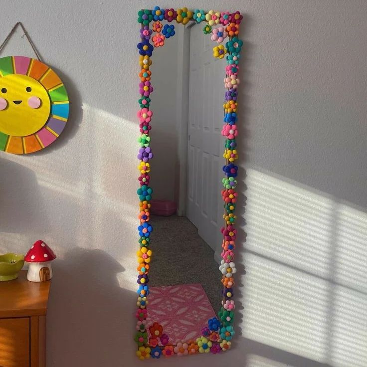 a mirror that has beads on it in the shape of a smiley face and is next to a door