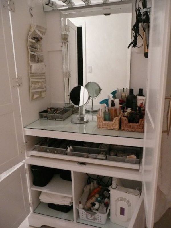 a white vanity with drawers and a mirror