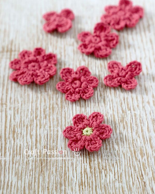 crochet flowers are arranged on a table top, ready to be made into appliques