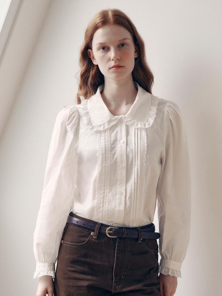 This elegant collar lace blouse is a versatile addition to your wardrobe. It features pintucks and lace on the body, with frills adorning the collar and sleeve ends. - Semi-cropped length that makes your look stylish- Made of cotton material with delicate frill details- Perfect for layering under a knit or dress, or as a standalone piece Classic Top With Lace Collar And Puff Sleeves, Classic Tops With Lace Collar And Puff Sleeves, Feminine Blouse With Ruffled Collar For Formal Occasions, Fitted Blouse With Cute Collar For Fall, Fitted Blouse With Detachable Collar For Workwear, Puff Sleeve Blouse With Lace Cuffs For Daywear, Elegant Collared Blouse With Lace Trim, Classic Fall Blouse With Lace Cuffs, Classic Daywear Blouse With Ruffled Collar