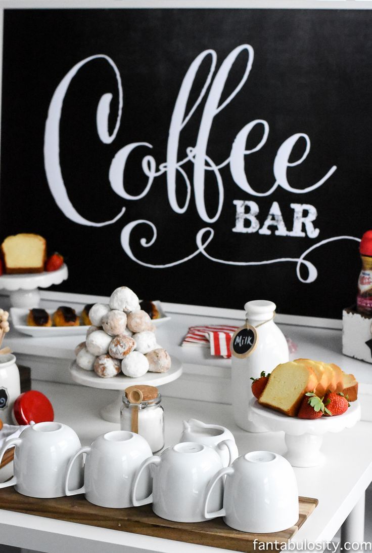 a coffee bar with cakes and pastries on it