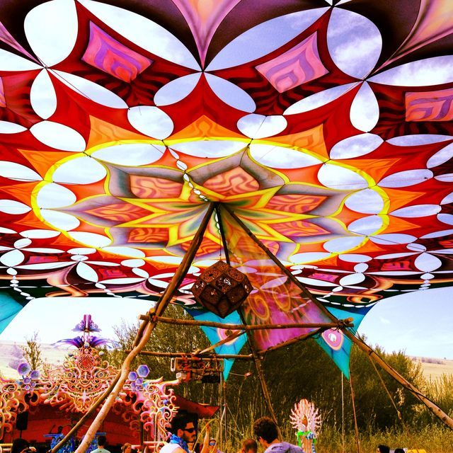 an elaborately decorated tent with people standing around it