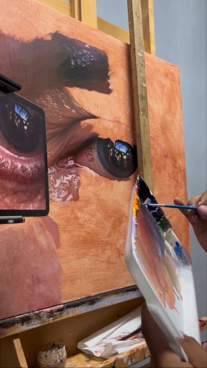 a person is painting an animal's face on a canvas