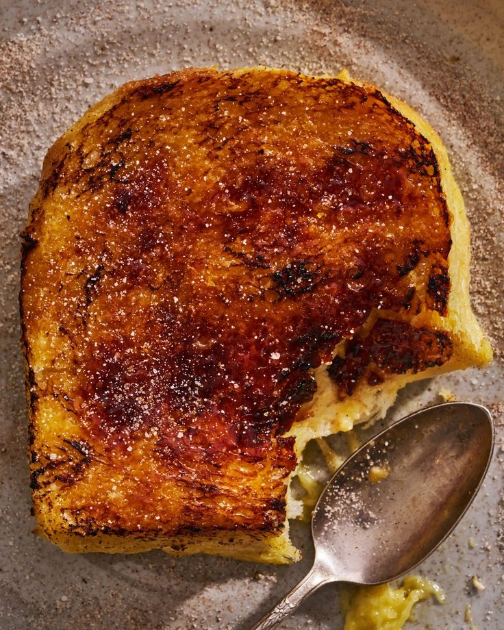 a piece of toast on a plate with a spoon