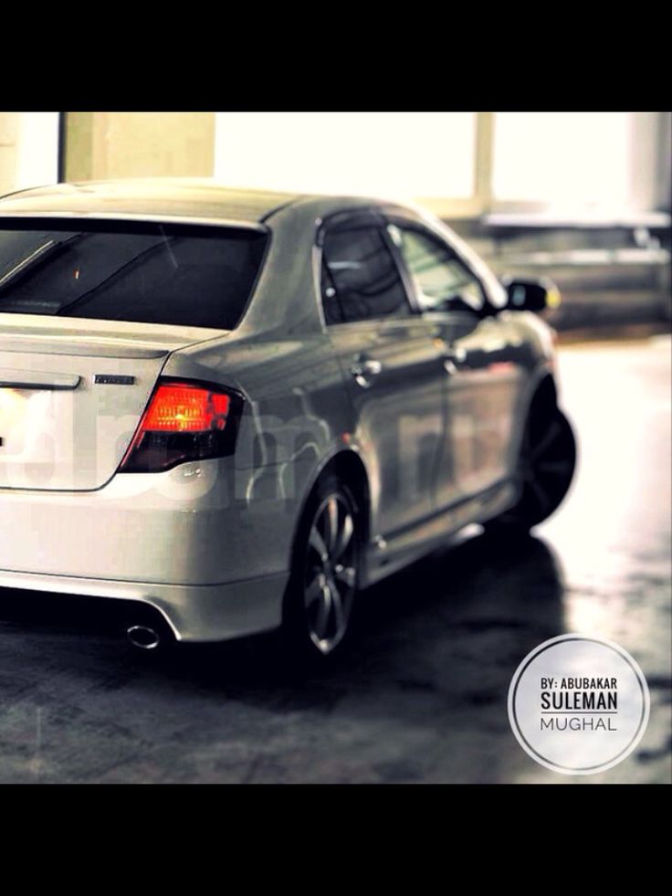 the back end of a silver car parked in a garage