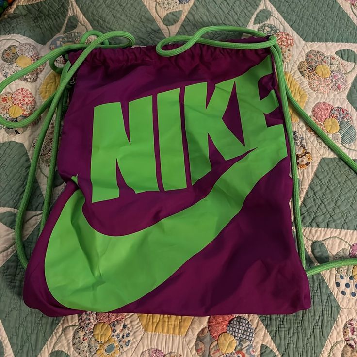 Bright Purple With Neon Green Nike Written. Different Than Most Bags As Zipper On Upper Left That Goes From One Side To Another! Never Used. Non Pet, Non Smoking Household Trendy Purple Bag With Dust Bag Included, Casual Purple Pouch Bag, Trendy Green Sports Bags, Purple Pouch Bag For School, Casual Purple School Bag, Nike Green Bags For Travel, Nike Green Travel Bags, Nike Green Sporty Bag, Nike Sporty Green Bag