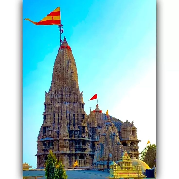 an ornate building with flags flying in the wind