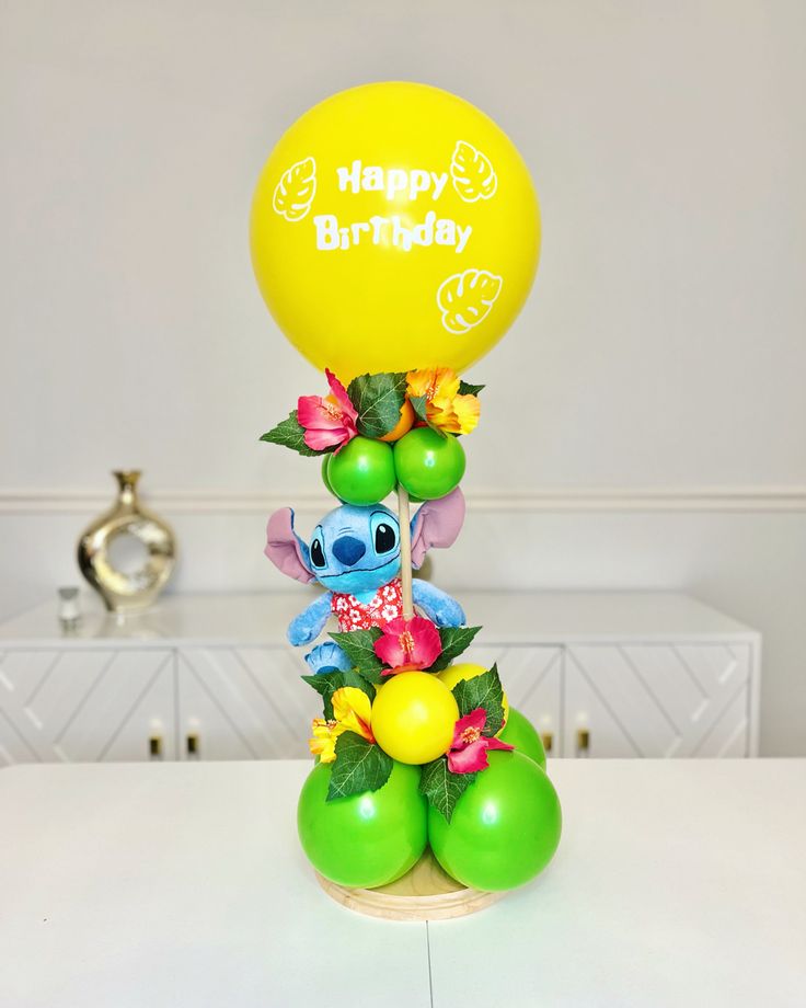 a birthday balloon sitting on top of a table