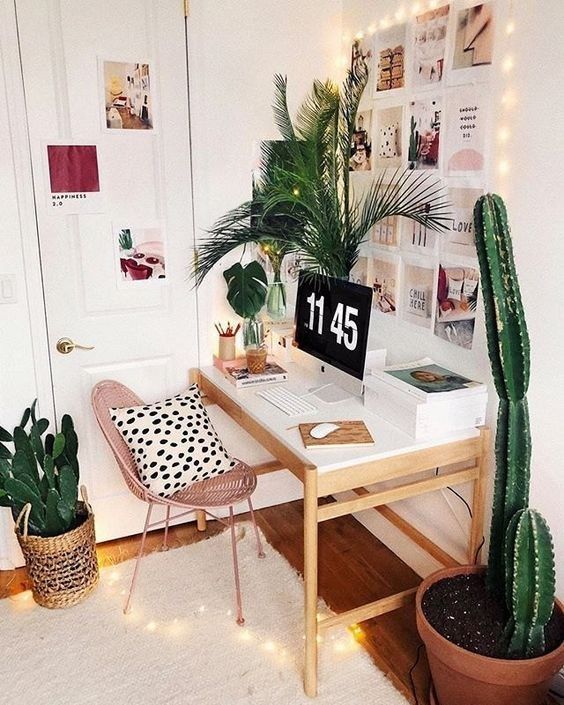 a desk with a laptop and cactus in a room decorated for christmas or new year's eve