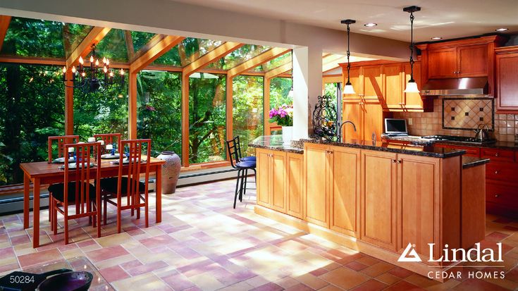 an open kitchen and dining room with lots of windows