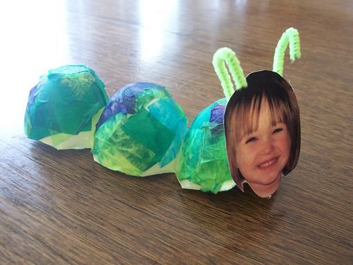 a child's paper mache made to look like a green caterpillar