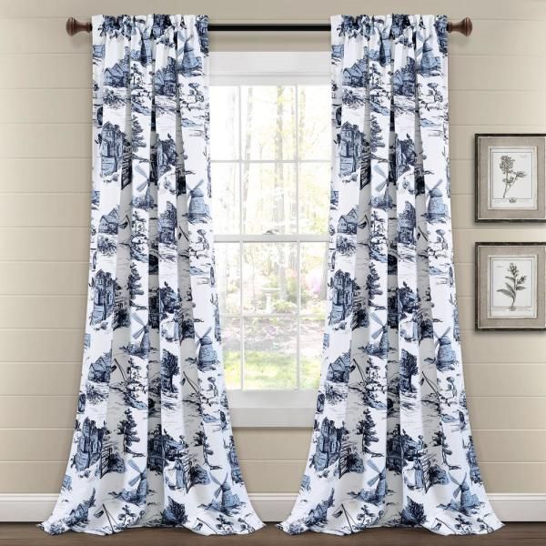 blue and white curtains hanging in front of a window