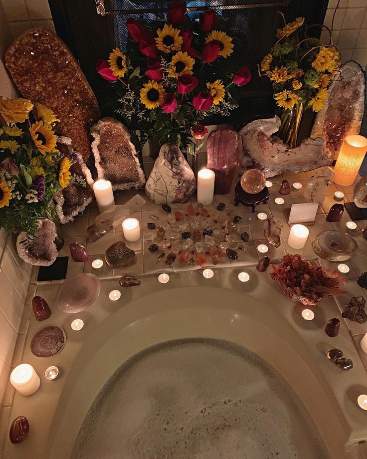 a bathtub filled with candles and flowers