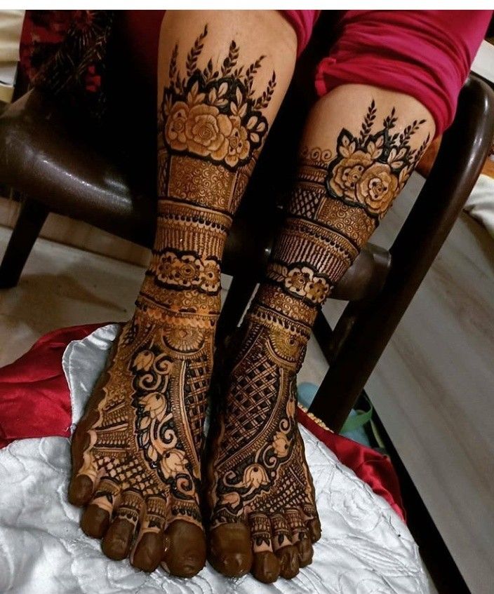 the legs and feet of a woman with henna tattoos