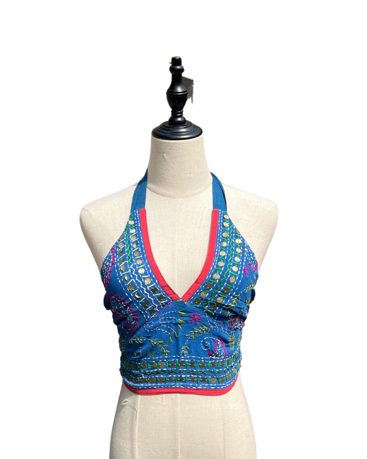 This vibrant, hand-embroidered bikini halter top offers stylish Boho-inspired fashion with its colorful threads and sequin embellishments. Paired with jeans or a skirt, this is the perfect summer top to stand out in and make a statement. The lining is a contrasting color to give it a unique, eye-catching look. One Size Made in India Care Instructions: Dry clean only Girl In The Mirror, Colorful Threads, Fur Purse, Inspired Fashion, The Mirror, Summer Top, Bright Orange, Perfect Summer, Bright Pink