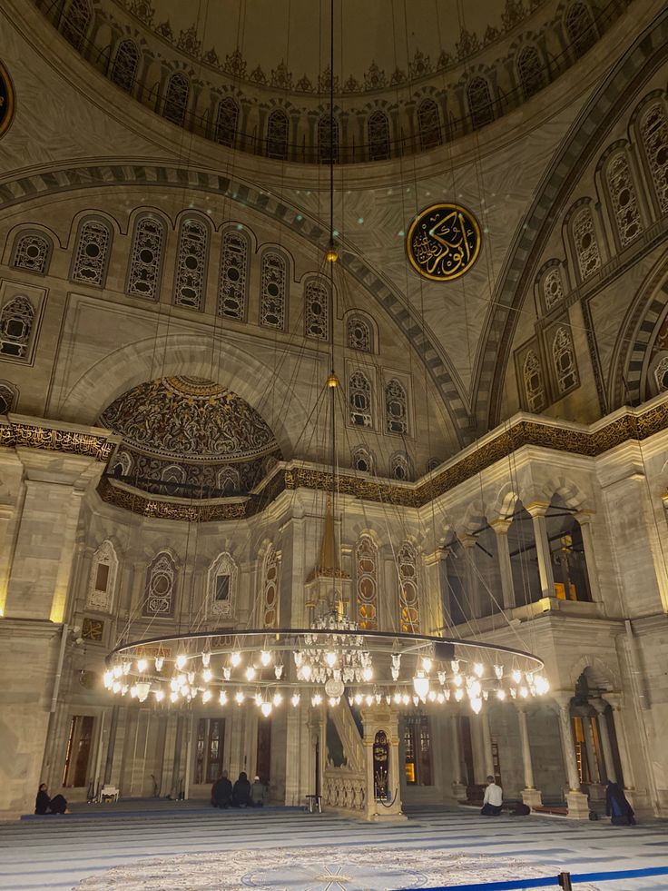 the inside of an ornate building with chandeliers hanging from it's ceiling